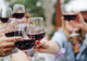 Three wine glasses with red wine in a celebratory toast