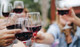 Three wine glasses with red wine in a celebratory toast