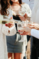 Wine being poured into several glasses